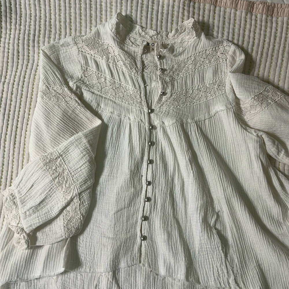 POL oversized small white gauze high low shirt with lace and silver buttons.